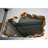 A gilt framed wall mirror