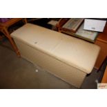 An upholstered ottoman and contents of various fab