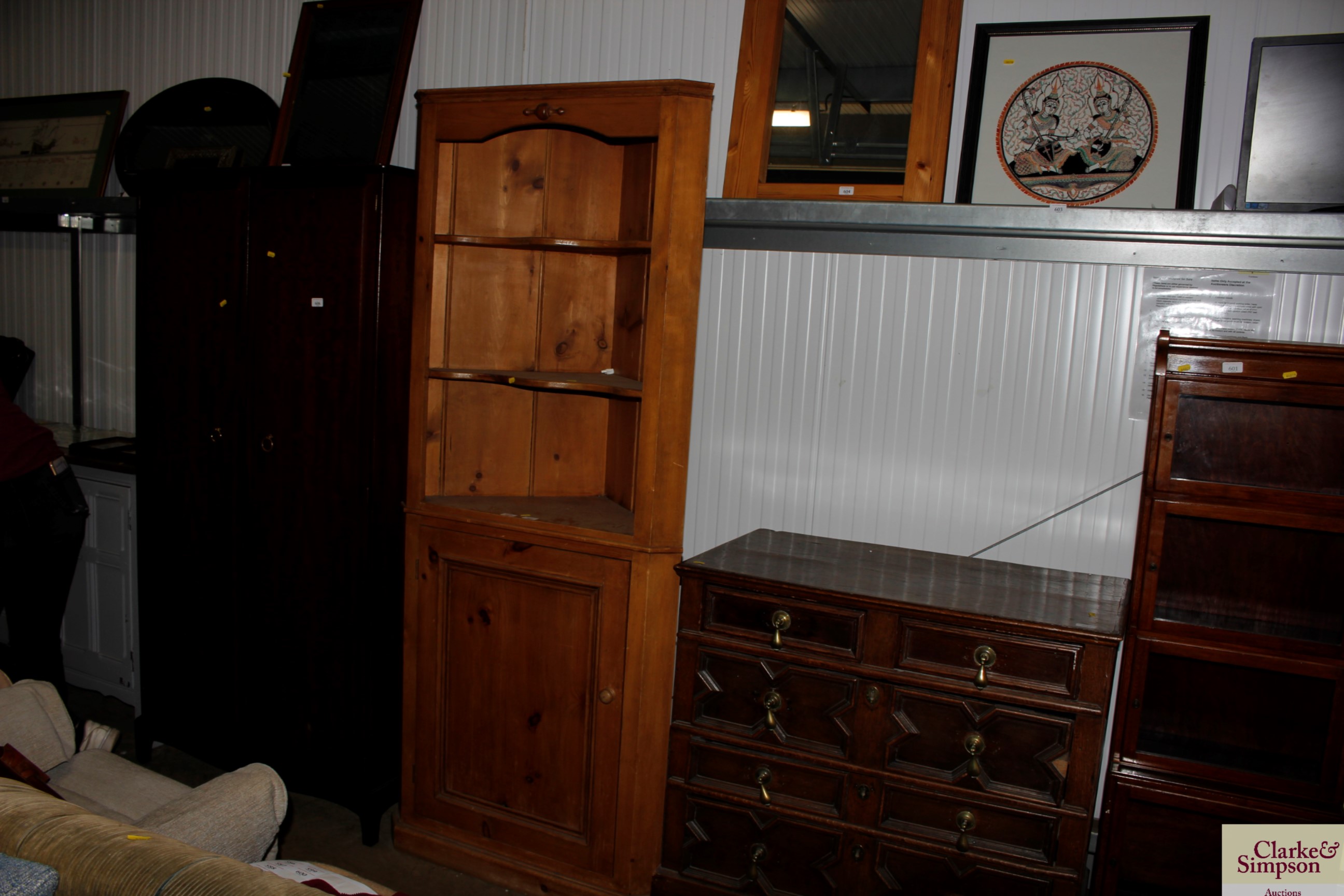 A stripped pine corner cupboard