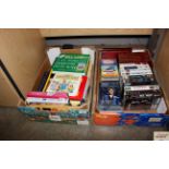 Two boxes containing various books and VHS tapes