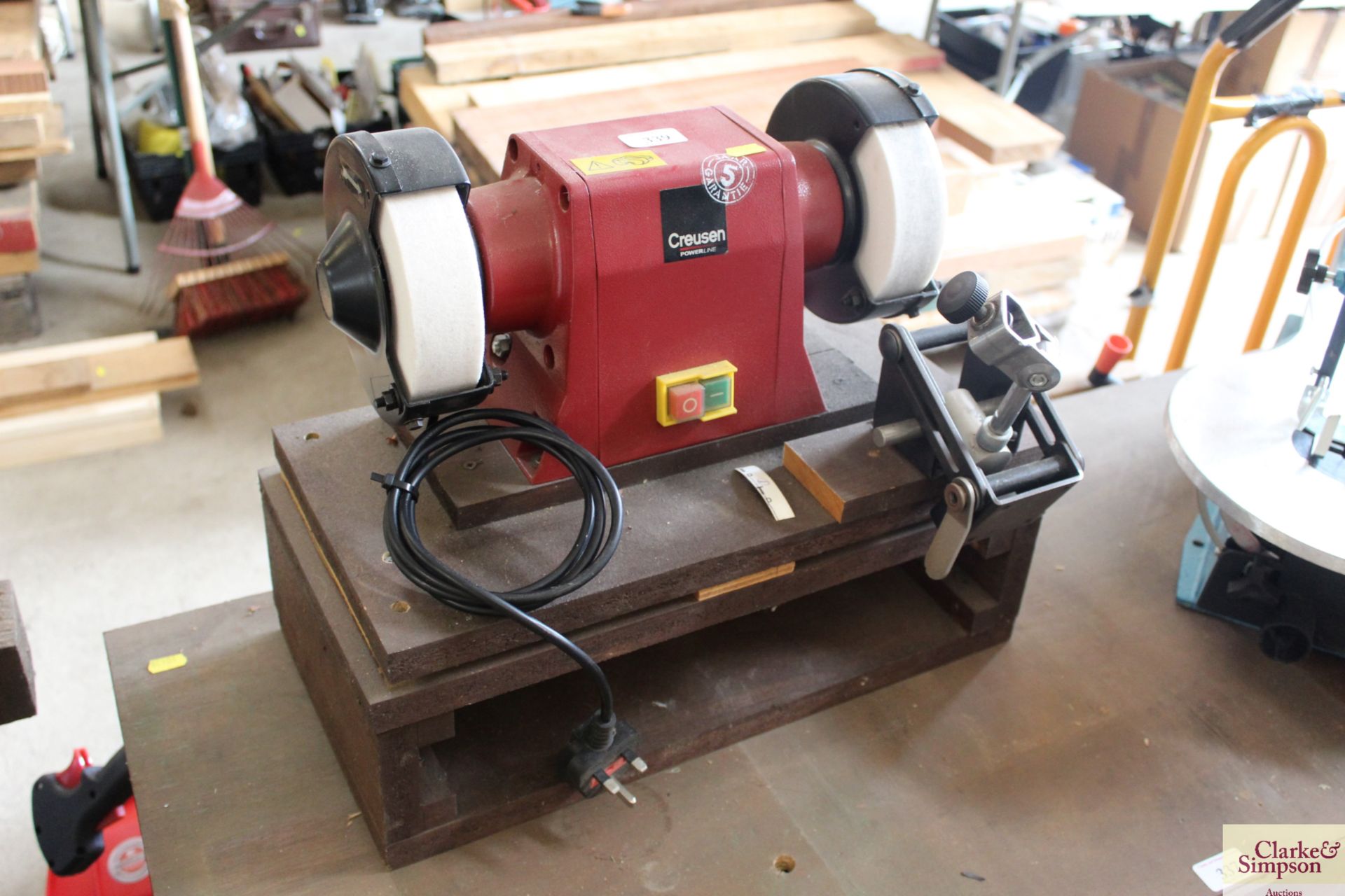 Creusen DS7500TS 240v double bench grinder with sharpening guide on wooden plinth.