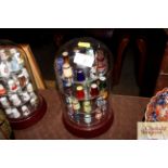 A display of various porcelain glass and other thimbles to include Bouchet Agatware, Murano and