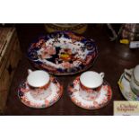 A pair of Crown Derby coffee cans and saucers; and