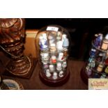 A collection of various porcelain thimbles under a