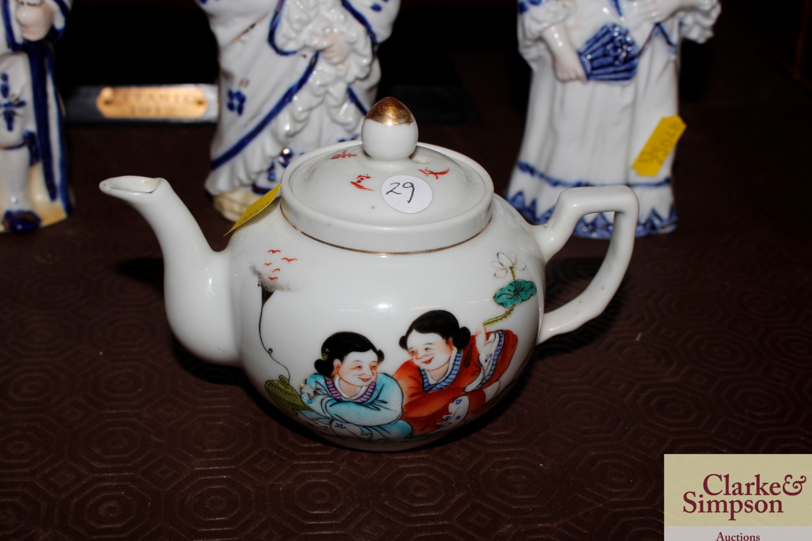 A small Chinese teapot decorated figures with char