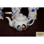 A small Chinese teapot decorated figures with char