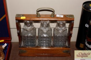 An oak and electroplate mounted three bottle Tanta