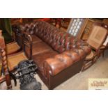 A leather upholstered button Chesterfield settee