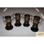 Four small silver trophy cups