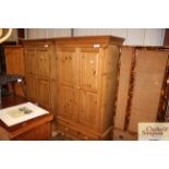 A stripped pine wardrobe fitted drawer to base