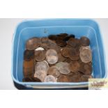 A blue plastic tub of various old copper coinage