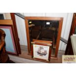 A wooden framed bevel edged wall mirror and a mod