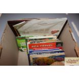 A box of various albums of tea cards etc.