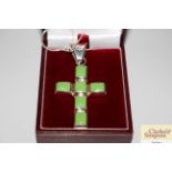 A green turquoise set cross and chain