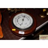 An oak cased aneroid barometer by R & J Beck Cornh