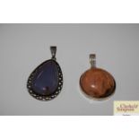 A silver banded agate pendant and a lapis similar