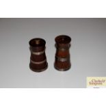 A pair of wooden and silver banded pepper mills