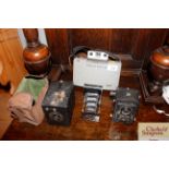 A vintage Polaroid camera, a box Brownie, a Voight