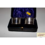 A pair of cased silver napkin rings