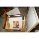 A box containing various pictures and prints