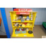 A vintage toy grocer's shop, with various miniature advertising items