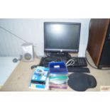 A Dell monitor; a Dell keyboard; various speakers