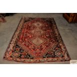 An approx. 8' x 5'4" red Eastern patterned wool ru