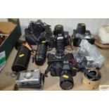 A quantity of various cameras and lenses to includ