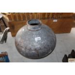 A small round metal water pot (143)