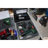 A Parkside cordless drill with charger and a Black