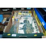 A box of various military plastic model kits and figures