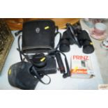A pair of Tasco 10 x 50 binoculars together with a