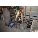 A quantity of long handled tools including forks,