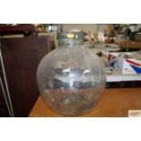 A clear glass carboy