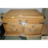 A desk top chest fitted three drawers