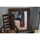 A rattan framed wall mirror