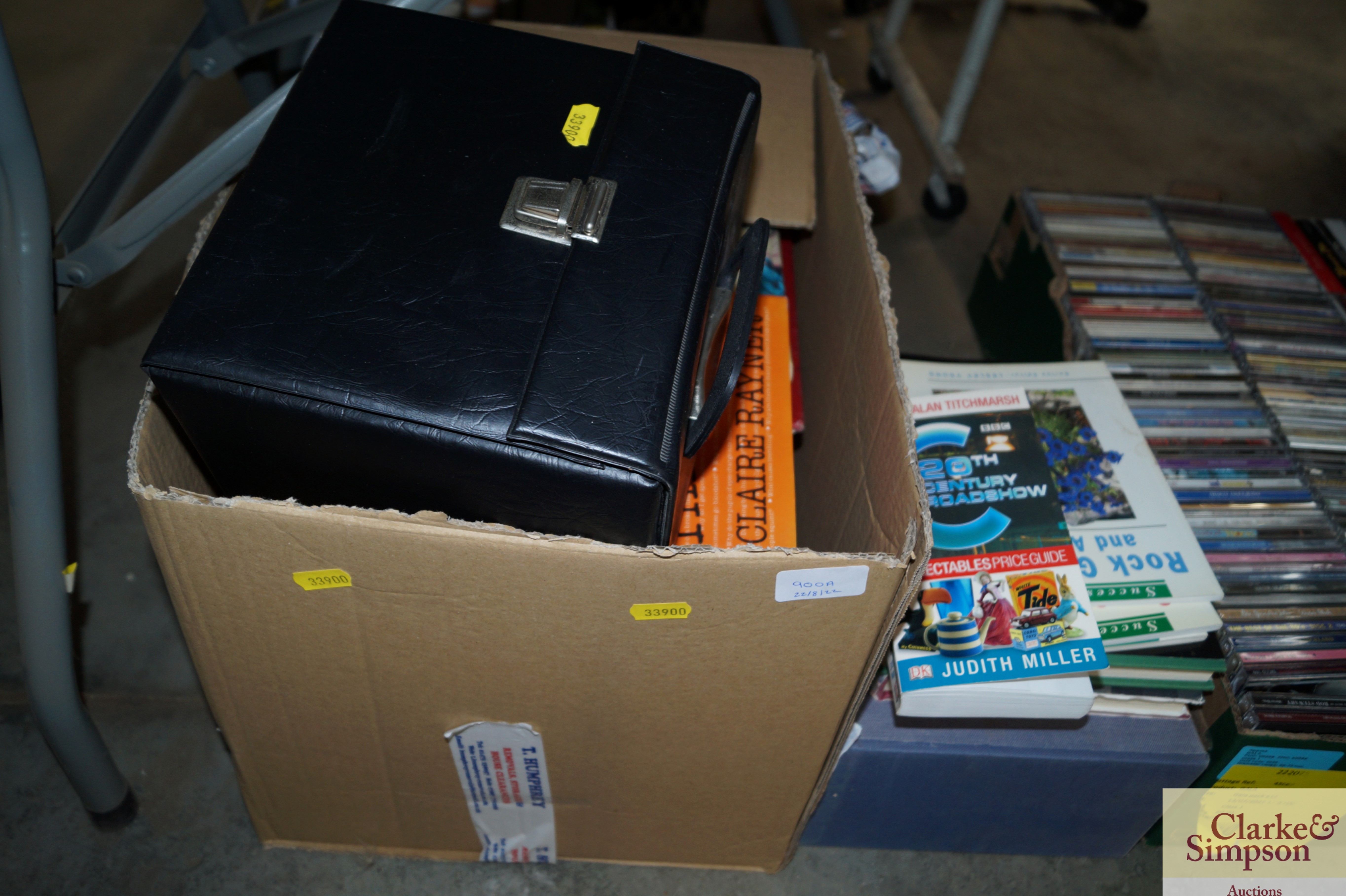 A box containing various books and LPs