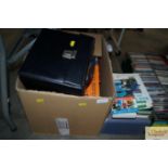A box containing various books and LPs