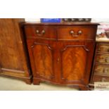 A reproduction mahogany serpentine front TV cabine