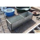 A long galvanised and metal garden planter