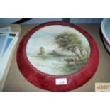 A painted and decorated plate depicting cattle wat