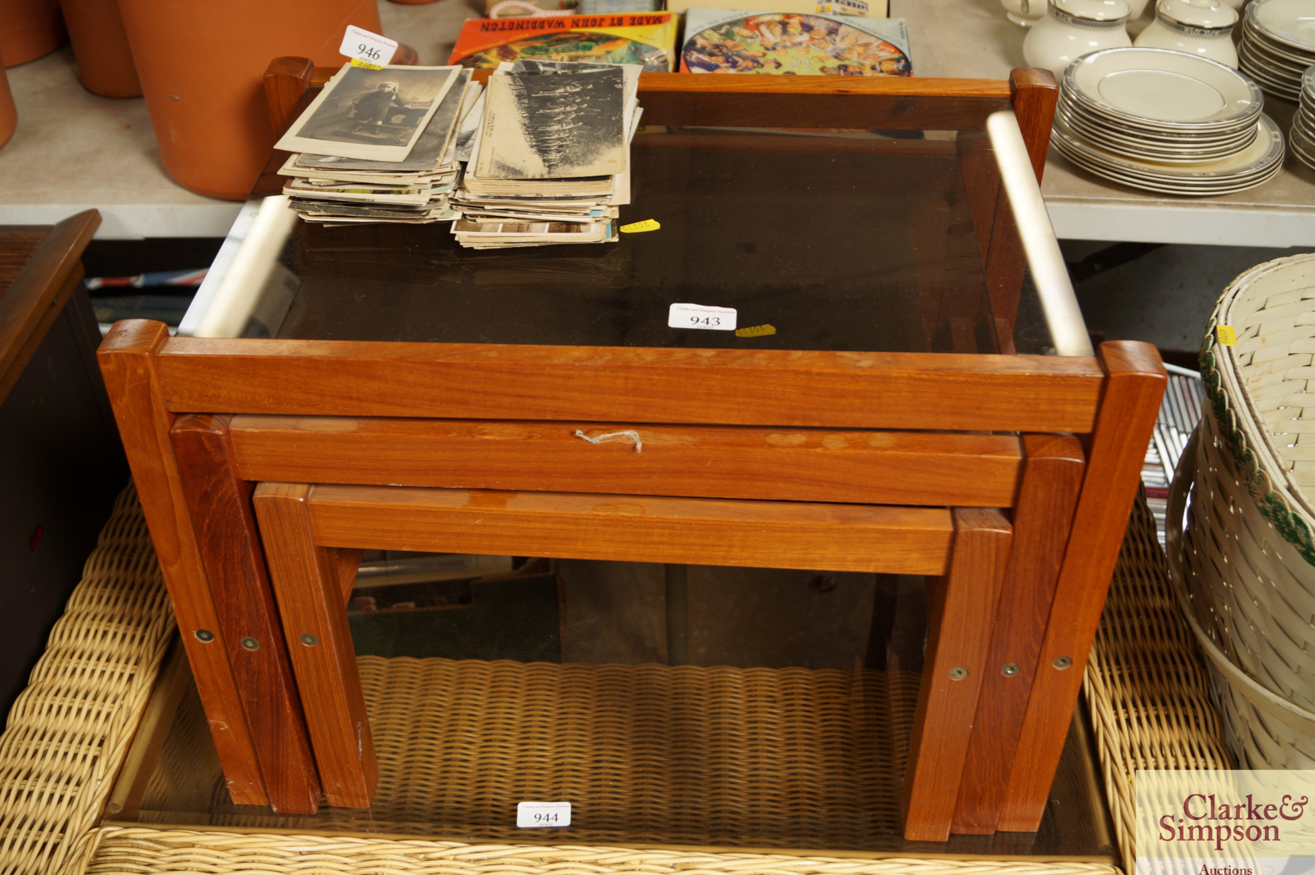 A nest of three glass topped tables