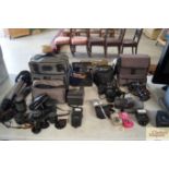 A collection of various cameras to include Cannon