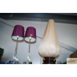 A table lamp with a silk shade together with a pai