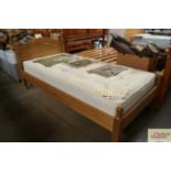 A pine single bed and mattress