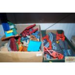 Two boxes containing various Thomas The Tank Engine train track, buildings and accessories