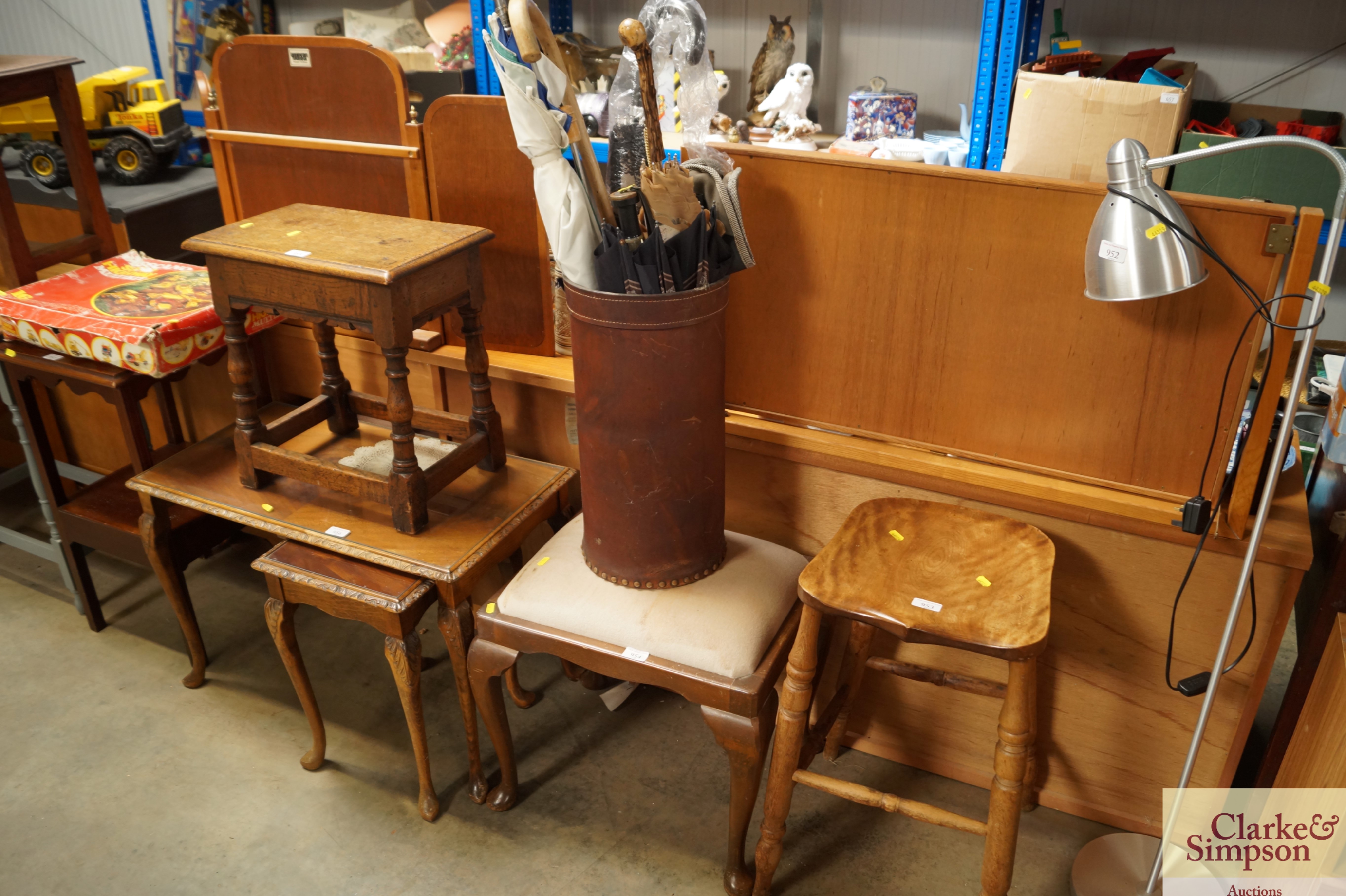 A faux leather umbrella stand with contents of umb