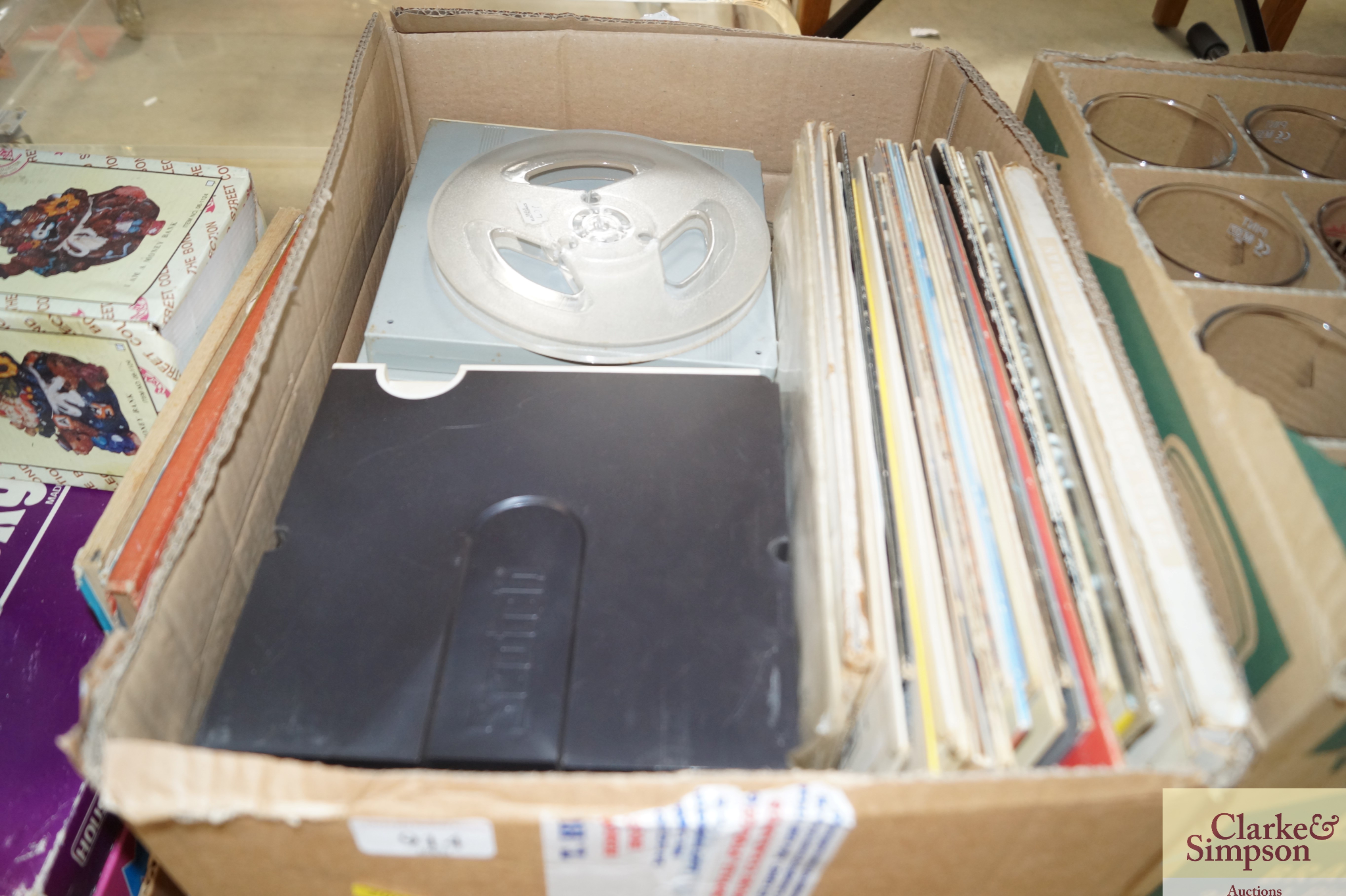 A box containing various LP's and reel to reel tap