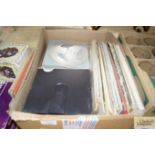 A box containing various LP's and reel to reel tap