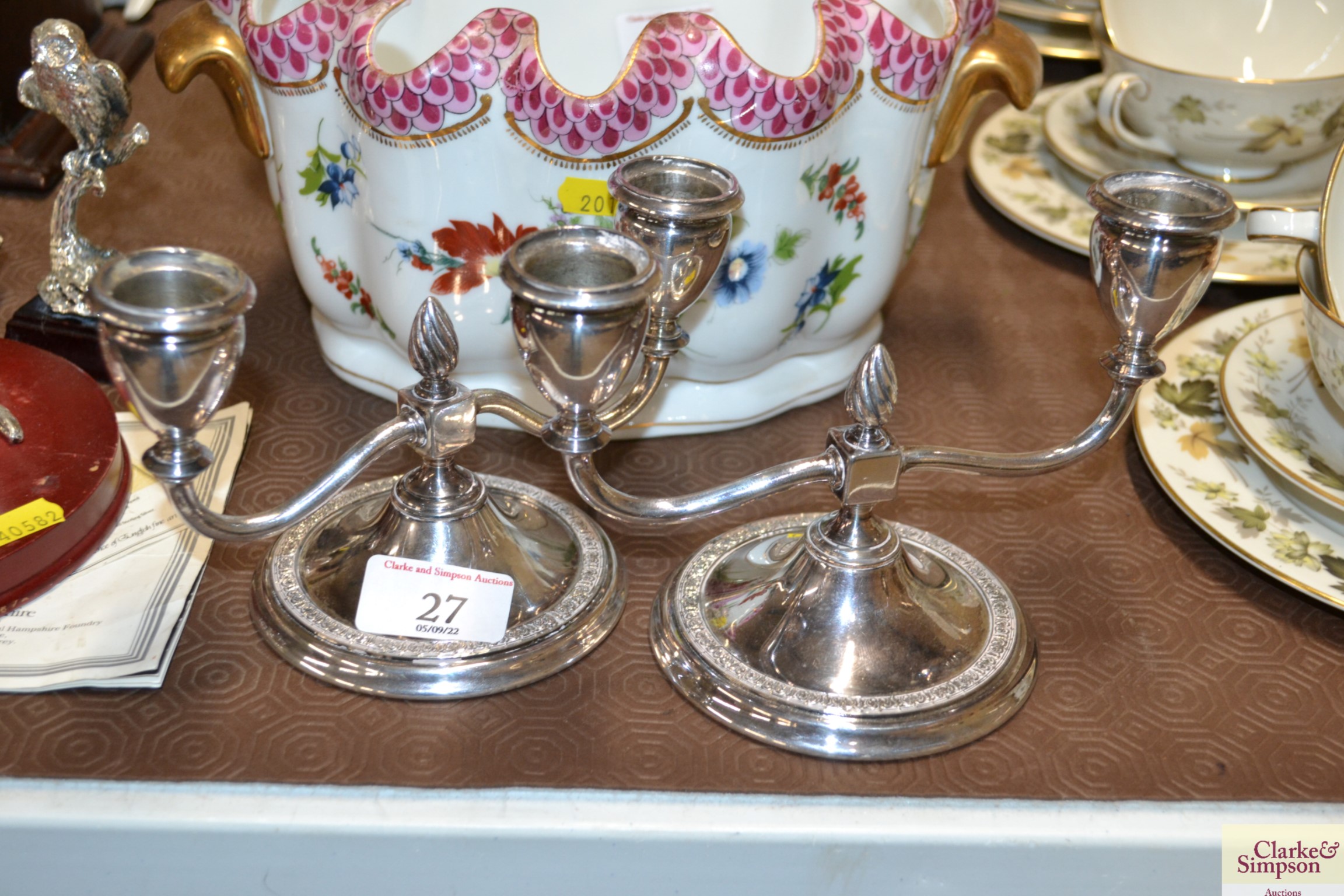 A pair of plated candlesticks, stamped Newcastle t